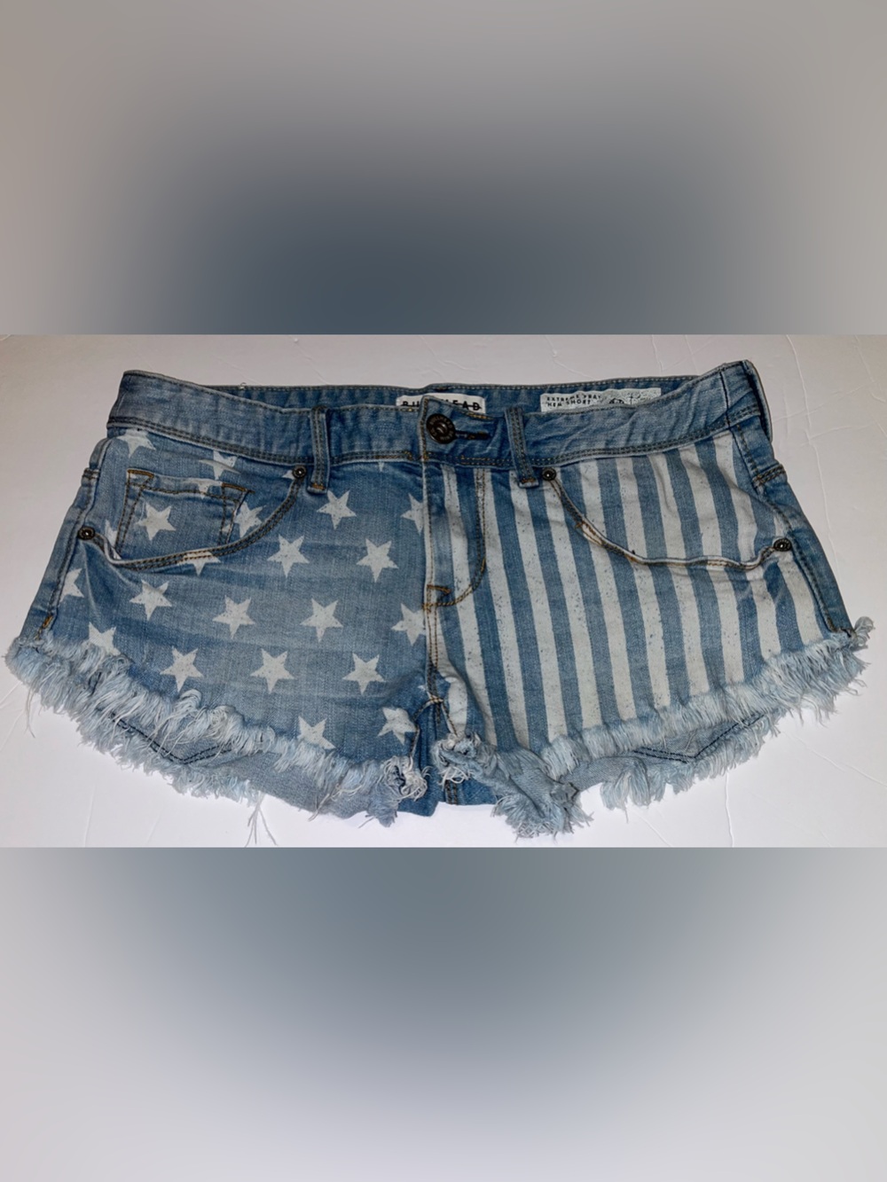 Bullhead Denim Co American Flag Shorts featuring an extreme frayed hem.
